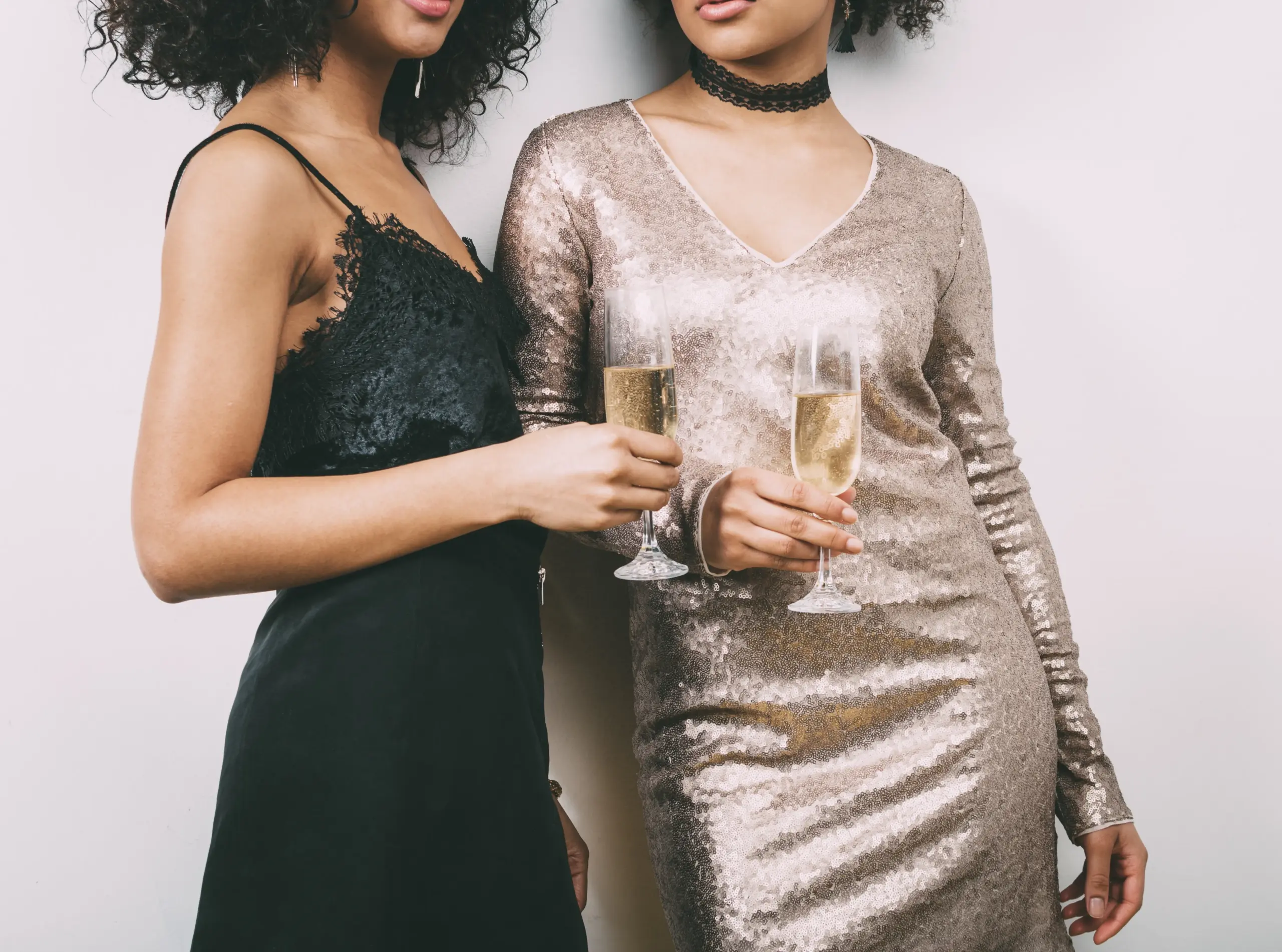 midsection women holding champagne glasses scaled