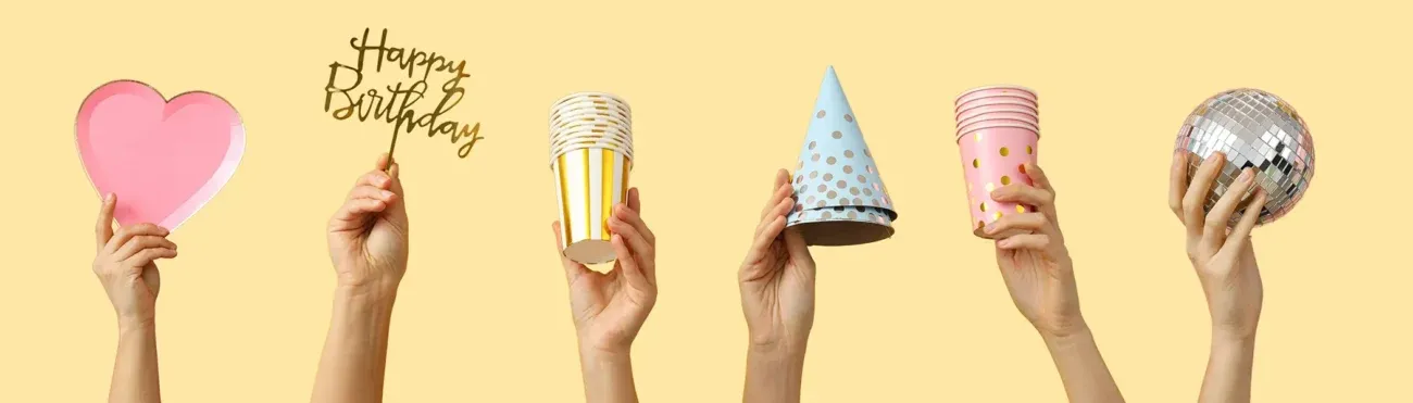 birthday party accessories set hands with birthday party accessories beige background